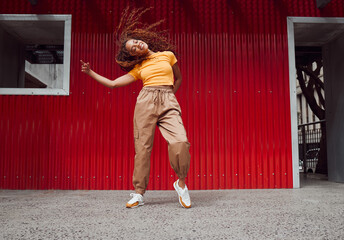 City, hip hop dance and an urban black woman in streetwear dancing outside in Sao Paulo. Music,...