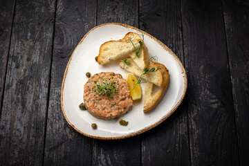 delicious salmon tartare with croutons and lemon