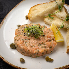 delicious salmon tartare with croutons and lemon