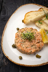delicious salmon tartare with croutons and lemon
