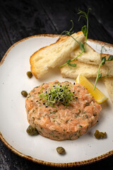 delicious salmon tartare with croutons and lemon