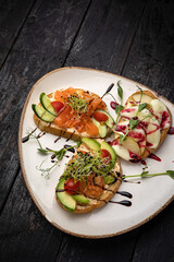 sandwich with salmon, avocado, tomato and cheese. healthy breakfast.