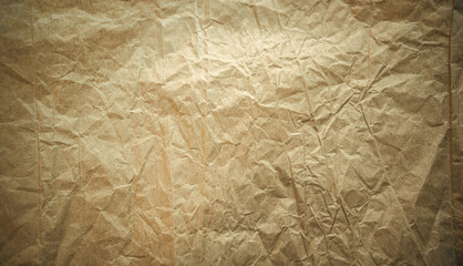 Crumpled craft paper. The texture of old crumpled paper for text. Yellow vintage cardboard backgrounds.