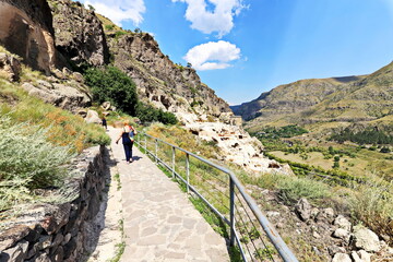 Fototapeta na wymiar Panoramic view of the nature of Georgia. The ancient cave city of Vardzia in the Caucasus mountains. Summer 201