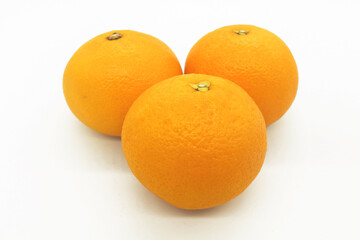 Fresh orange fruits isolated against a white background
