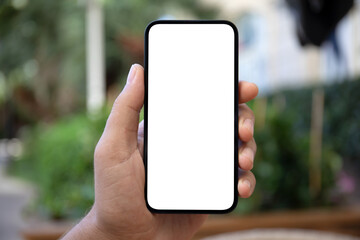 male hands holding phone with isolated screen background green street