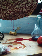 still life making witchery spell on apple with blood on mirror - halloween horror concept