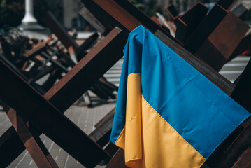 The Ukrainian flag hangs on barricades in the city