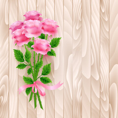 Bouquet of pink roses on wooden background.