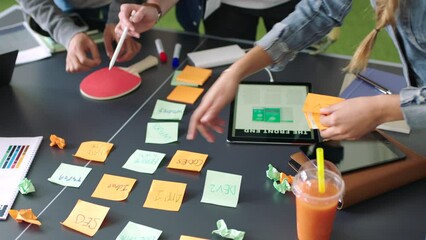 Team, hands and planning with sticky notes, post it and table for brainstorming, strategy and meeting at the office. Hand of creative group working on business schedule, task or project plan