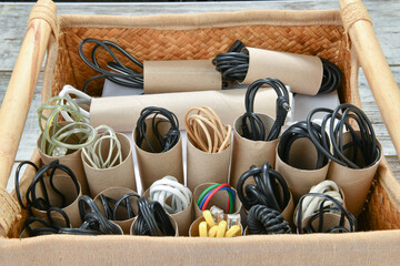 Organizing power and USB cables using empty toilet paper tubes in shoebox 