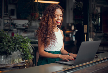 Laptop, working and black woman typing at a cafe, networking on the internet and planning work at a...