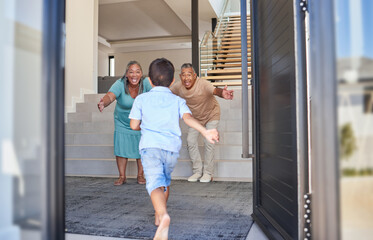 Excited kid running to grandparents in family home meeting, greeting and hugging with love, care...
