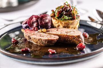 Creatively duck breast served on a ceremonially prepared table in the hotel restaurant