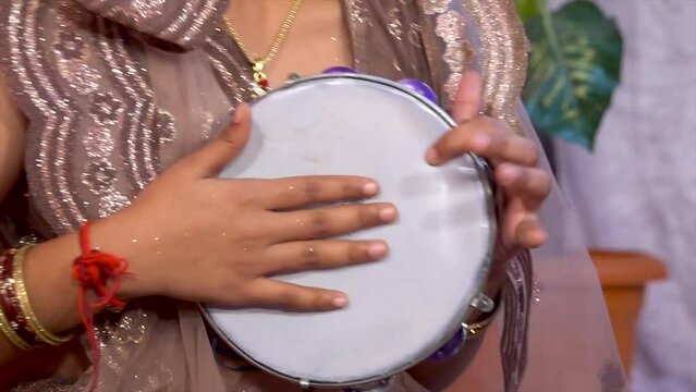 girl are playing a Tambourine Khanjari (Dafli) instrument. Beautiful Young Woman Holding Tambourine (Dafli). Playing tambourine Khanjari (Dafli) when traditional shows become commonplace.