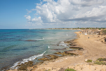 Beautiful beach with sand, turquoise and green water and dunes in Portopalo di Capopassero