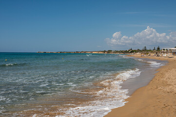 Beautiful beach with sand, turquoise and green water and dunes in Portopalo di Capopassero