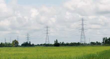 High-voltage electric lines, towers and industrial infrastructure against the cloud sky.