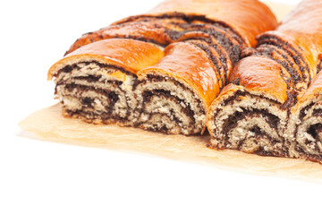 poppy seed strudel on a brown baking paper isolated on white