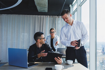 Caucasian male CEO businessman leader with team of diverse colleagues, group executive managers at meeting. Multicultural professional business people working on research plan in boardroom.