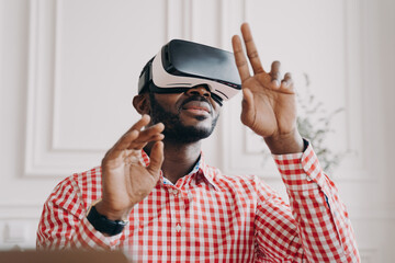 Black man in VR glasses experiencing 3D technology of augmented reality
