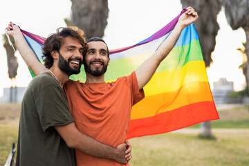 Happy couple with a pride flag. LGBT community