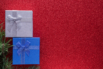 Christmas red background with fir branches with copy space.