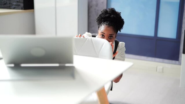 Scared Female Hiding Under Desk