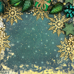 Christmas green tree decorations and gold snowflake border on grunge background. Traditional festive Xmas abstract design for the Xmas and New Year holiday season.