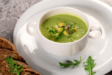 Fresh healthy green spinach cream soup. Vegan cuisine