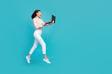 Fototapeta na wymiar Full body size photo of excited dreamy woman wear formal outfit jumping with netbook watching new youtube video hobby isolated on blue color background