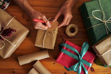 Man wrapping Christmas gift with craft paper. Christmas or New year DIY packing Concept. 