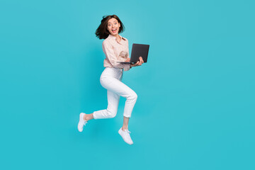 Side profile photo of impressed crazy business lady jumping trampoline hurry hold computer...