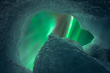 Amazing view of aurora borealis throughout hole in ice cave