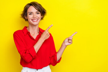 Photo of adorable gorgeous girl with bob hairstyle wear red shirt fingers directing empty space...