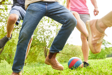 Fototapeta premium Young people playing football in the park