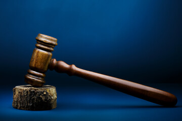 Judges hammer or Gavel close-up on a blue background fine art.