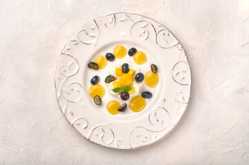 Flat lay panna cotta homemade with natural vanilla pod, mango syrup, grape and mint, high key