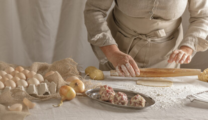Women’s hands, flour and dough. A woman is preparing a dough for home baking. Concept of home cooking with organic and natural ingredients. Zero waste concept
