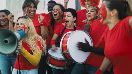 Multiracial football fans exulting while watching soccer game at stadium - People with painted face screaming and encouraging their favorite team - Sport entertainment concept