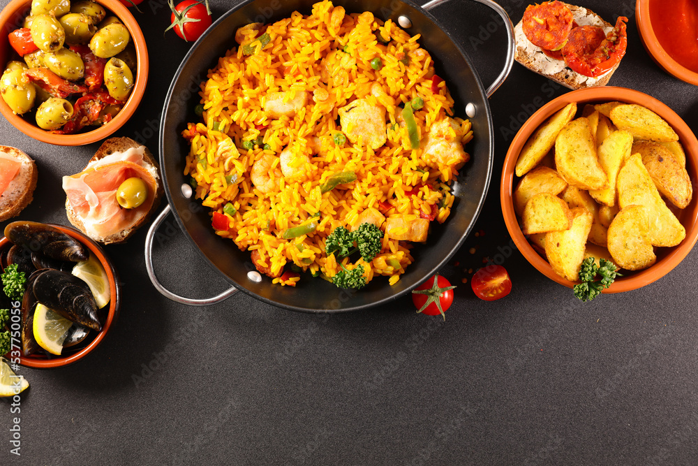 Wall mural spanish paella and traditional tapas(potato brava, mussels, toast)