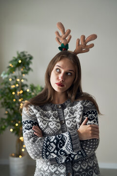 Caucasian woman with funny horns looking away during the Christmas