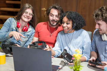 Team of gamers, young people and different influencers having fun while testing headset and portable device for gaming, streaming and broadcasting influencer concept, focus on biracial woman