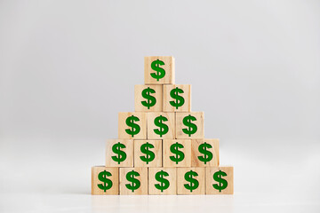 Dollar signs on wooden block pyramid