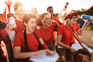 Football fans having fun supporting their favorite team - Soccer sport entertainment concept