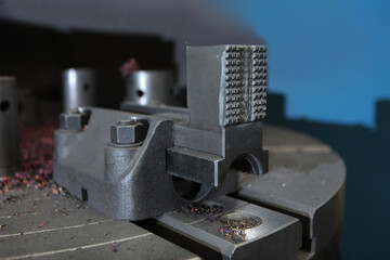 Metal vise to hold the part. The metal clamp is in production. Metal products. Heavy industry.