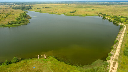 Top view of a motor road along the lake on a summer day