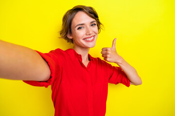 Portrait of adorable gorgeous girl with bob hairstyle wear red shirt doing selfie showing like isolated on yellow color background