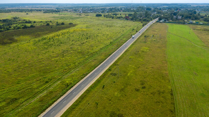 Top view of a road on a flat terrain on a summer day