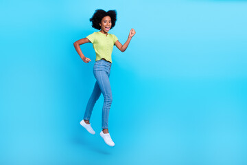 Fototapeta na wymiar Full body length photo of jumping air trampoline stylish outfit girl celebrate summer season sale low prices fists up empty space isolated on blue color background